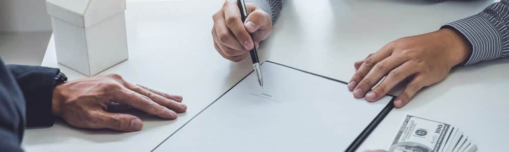 high-angle-view-man-signing-documents-desk