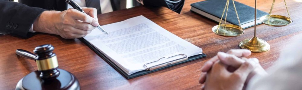 midsection-lawyer-discussing-document-with-client-courtroom