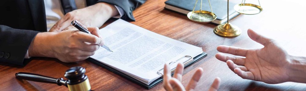 midsection-lawyer-discussing-document-with-client-courtroom