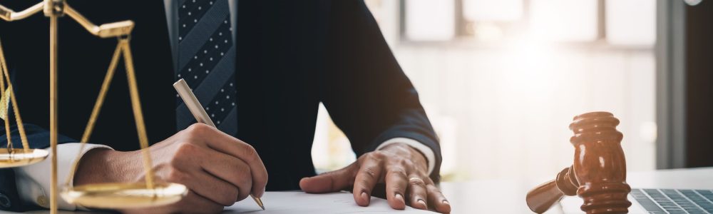 midsection-lawyer-writing-document-office